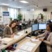 Business owner completing business name registration paperwork at a county clerk's office.